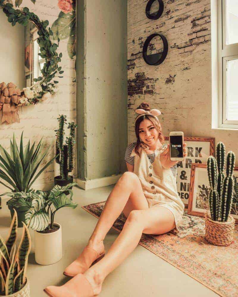 Girl sitting on floor near plants